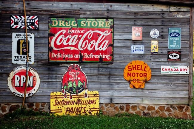 wooden side of house display vintage tin signs