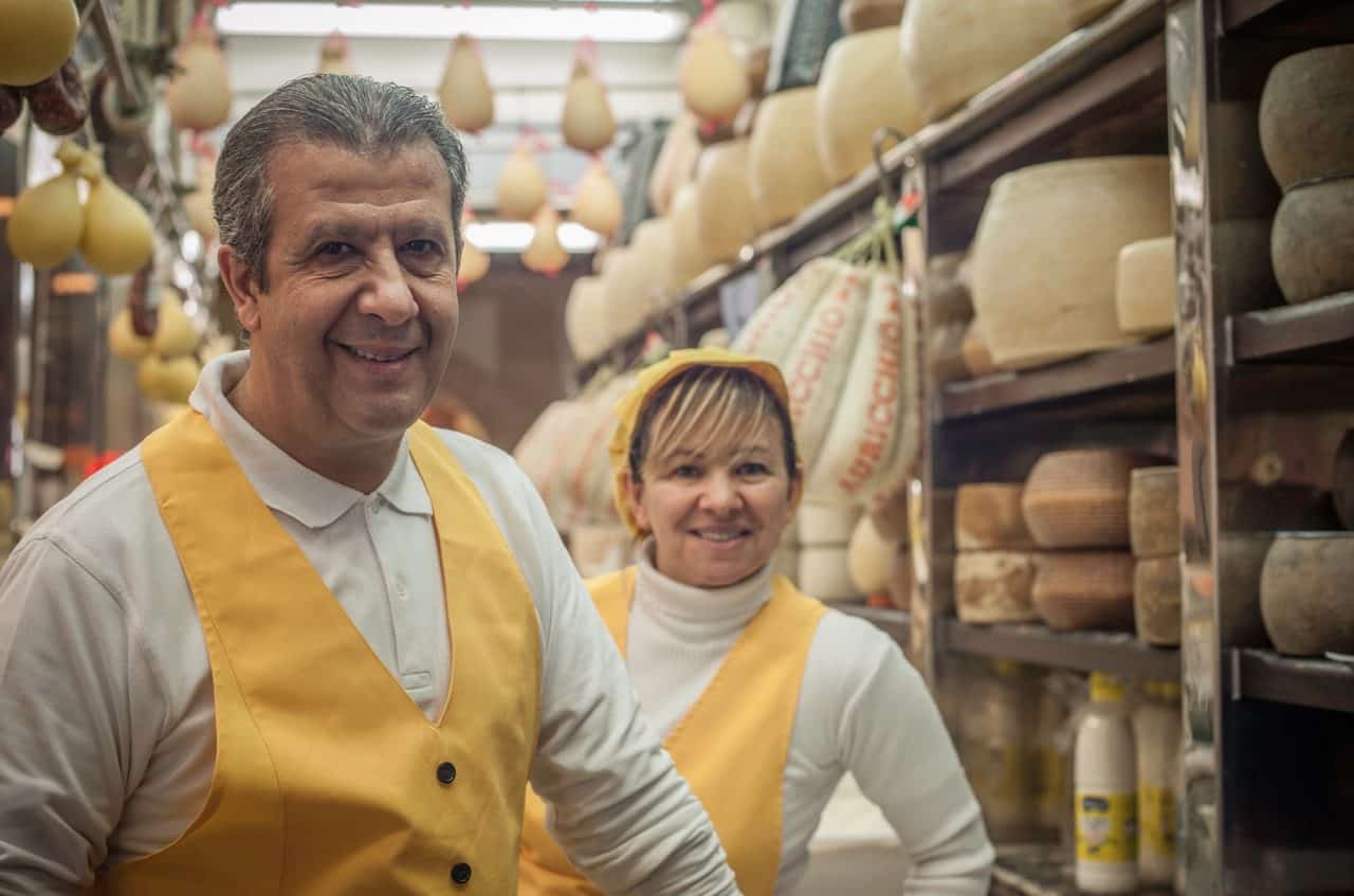 a couple working in a cheese shop