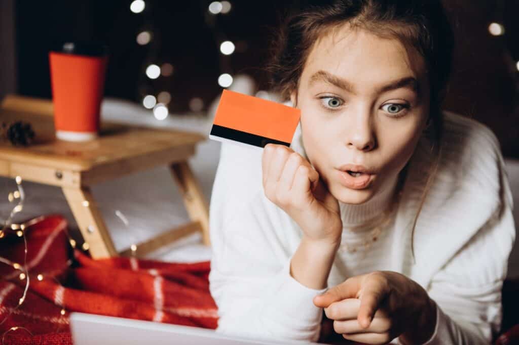 surprised teenage girl receiving a gift card